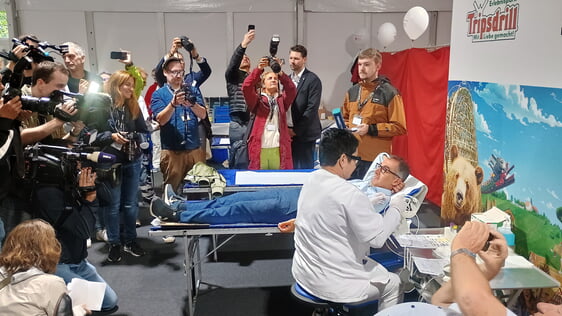 Der diesj&auml;hrige Schirmherr Cem &Ouml;zdemir, umringt von Fotografen w&auml;hrend seiner Blutspende